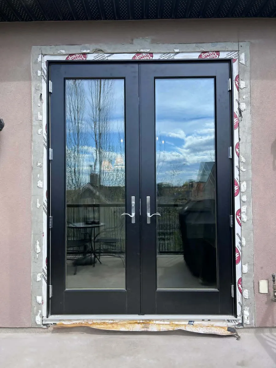 Balcony doors before stucco — plain opening with no trim or moulding
